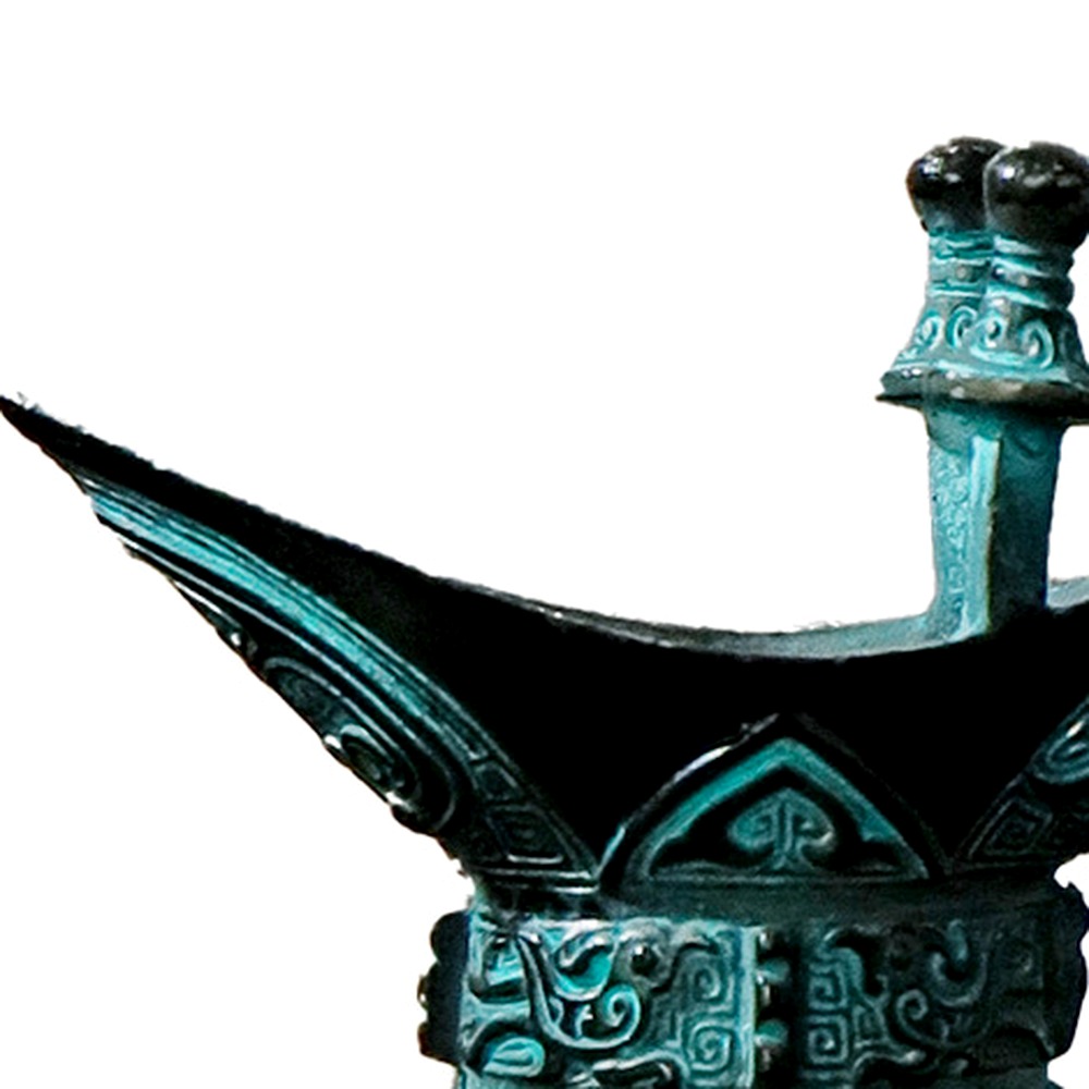Close detail of the small bronze Jue cup rim, single post and visible motif