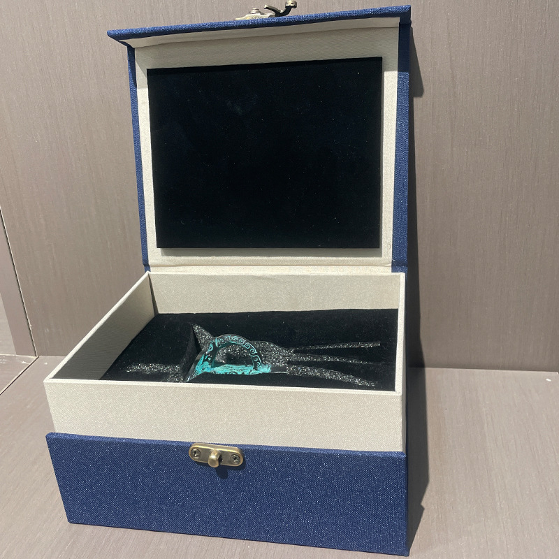 Small bronze Jue cup fitted inside an open blue gift box with black insert