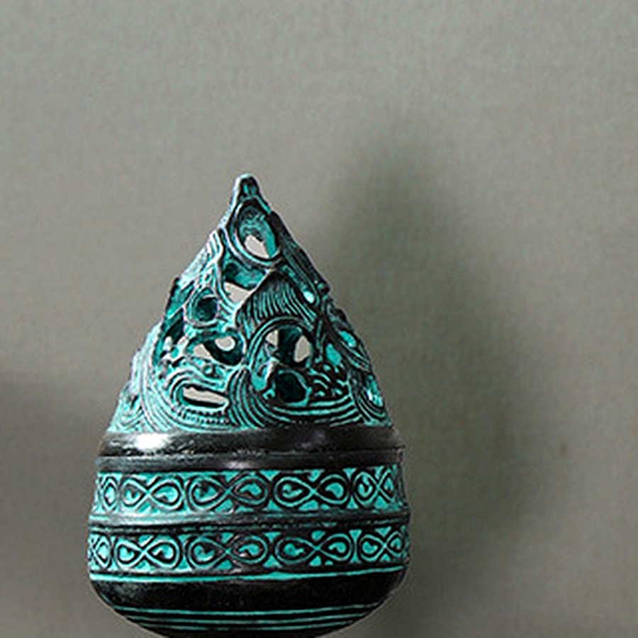 Surface detail on a modern small bronze incense burner with lid