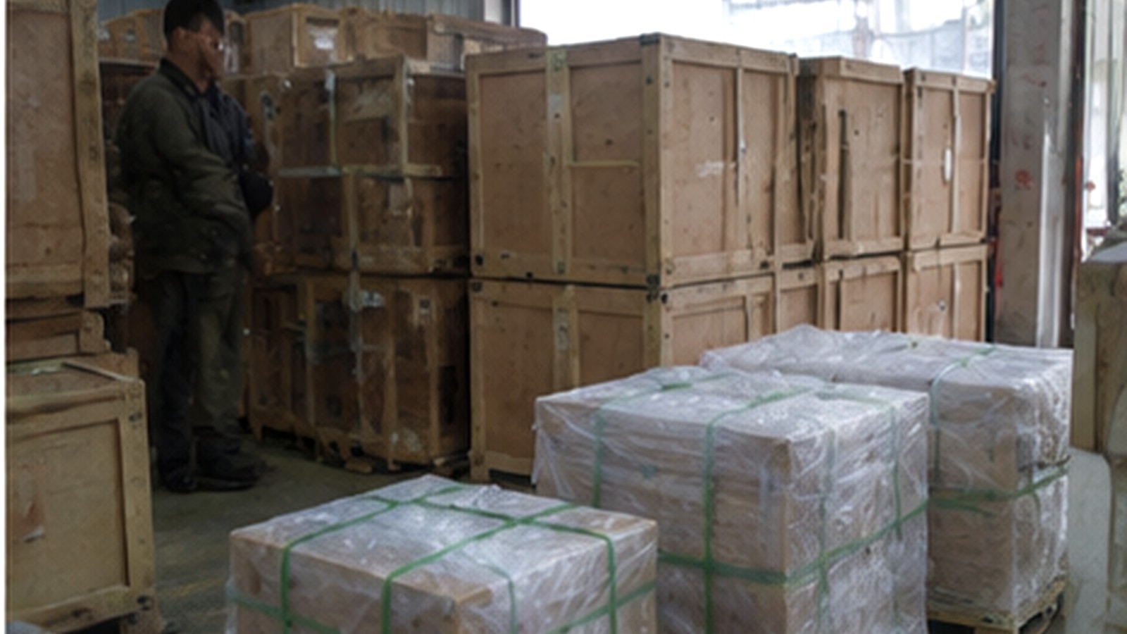 Wooden crates and wrapped parcels in a workshop packing area