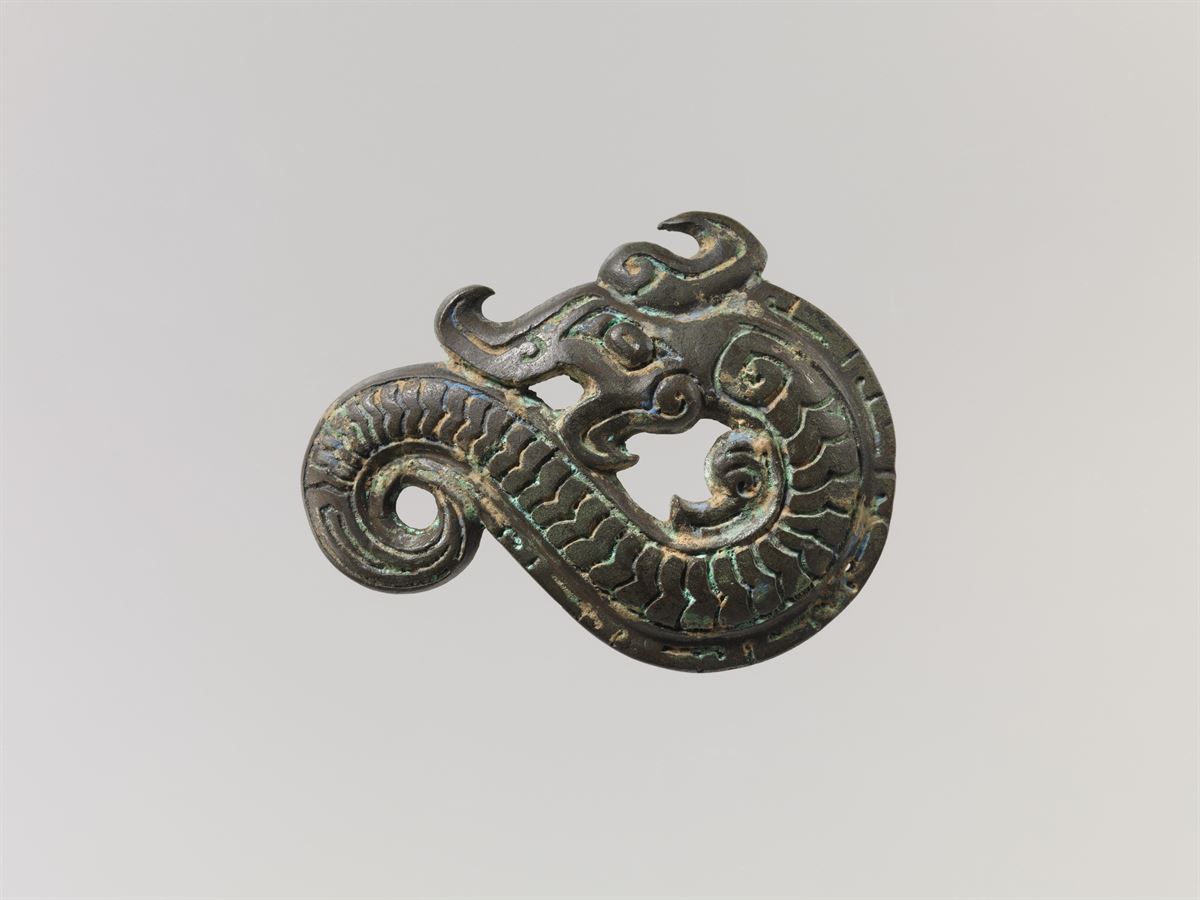 The Met's bronze dragon-form applique, shown in full, object 1985.214.39